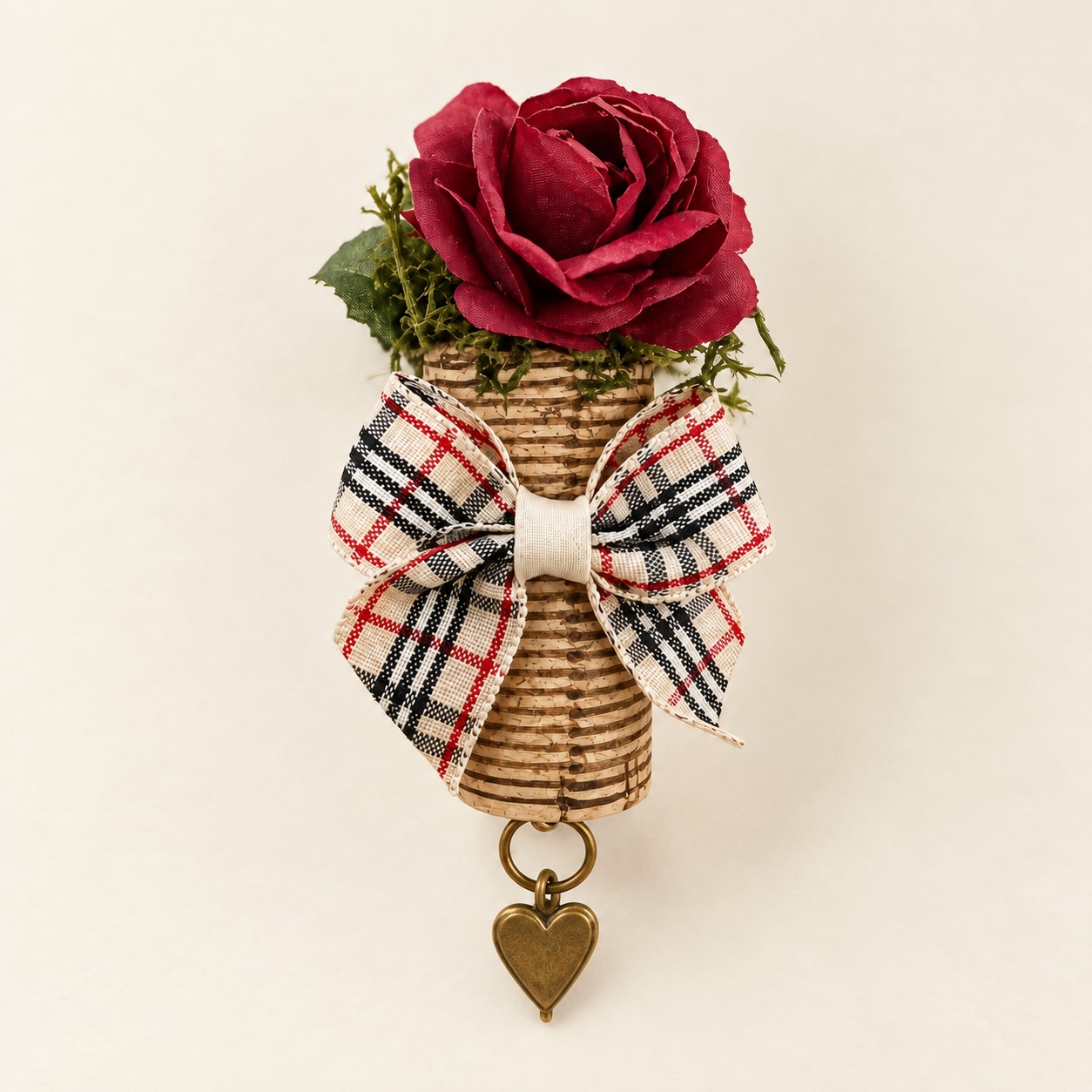 a burgundy rose cork magnet with cream tartan bow