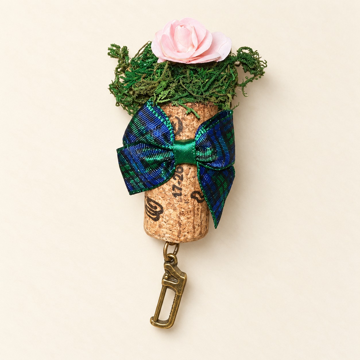 a pink rose cork magnet with tartan bow and saw charm