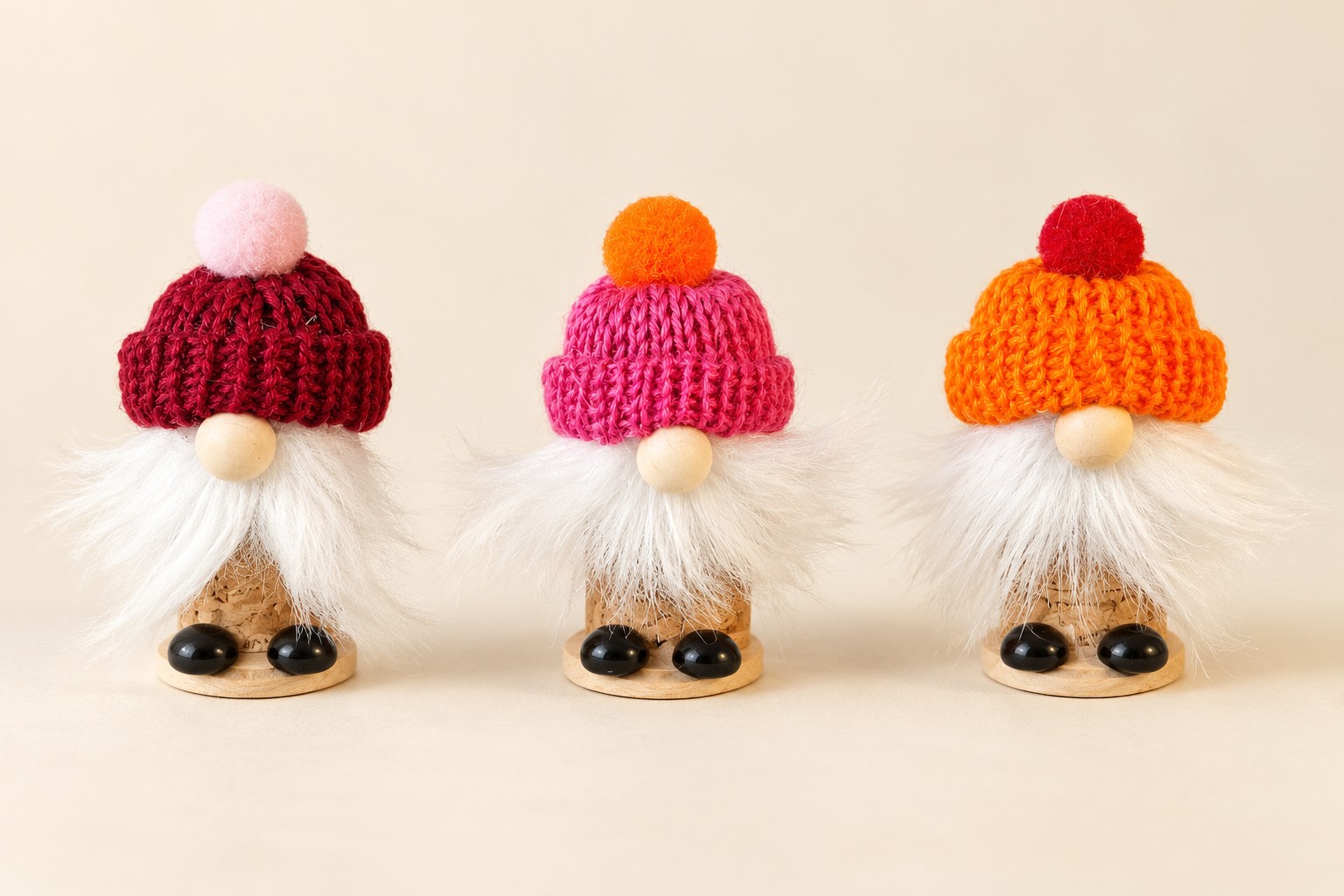 three handmade cork gnomes with colourful knitted hats and white beards