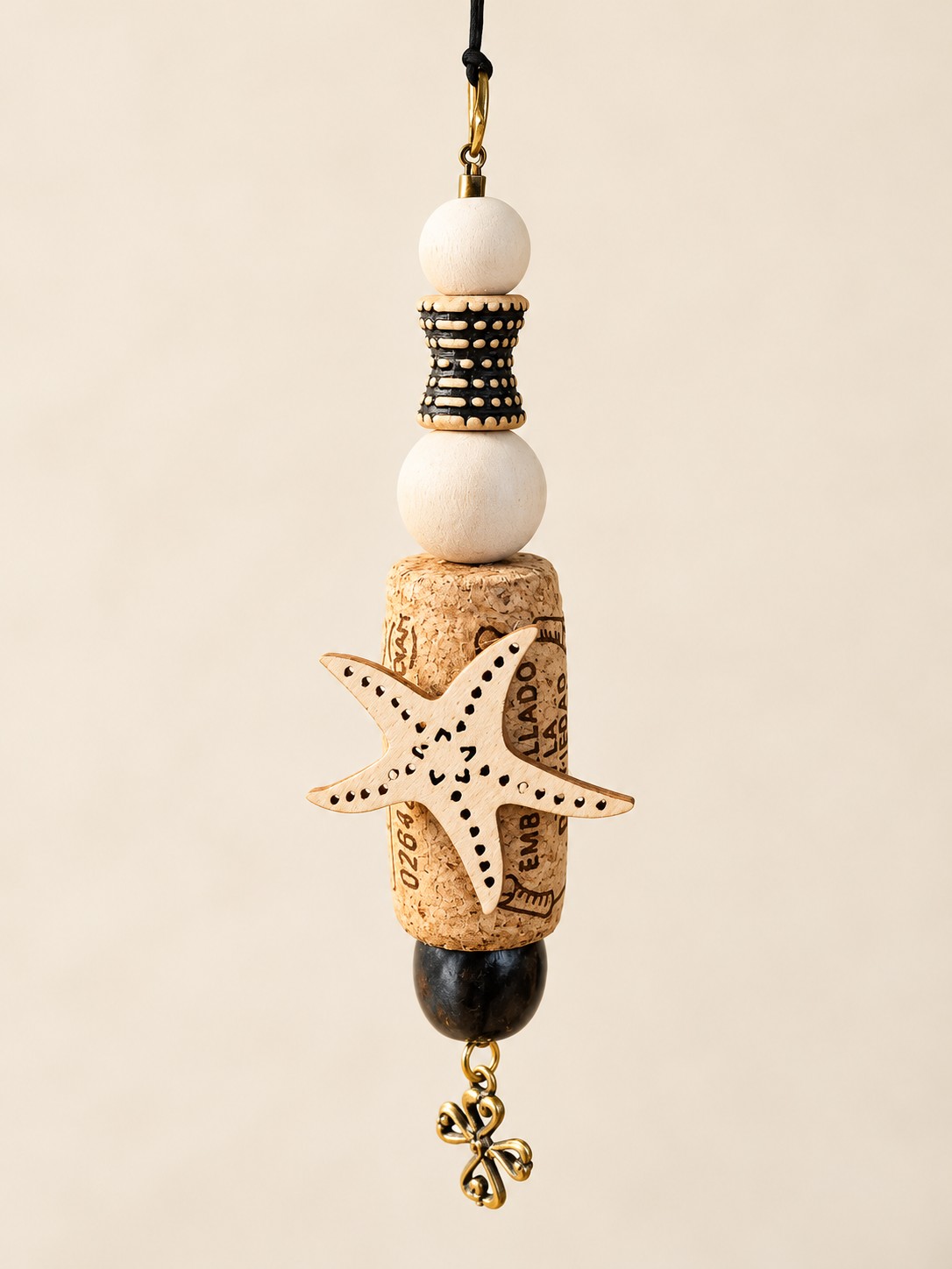 a starfish cork hanging decoration with cream beads, patterned spacer and flower charm